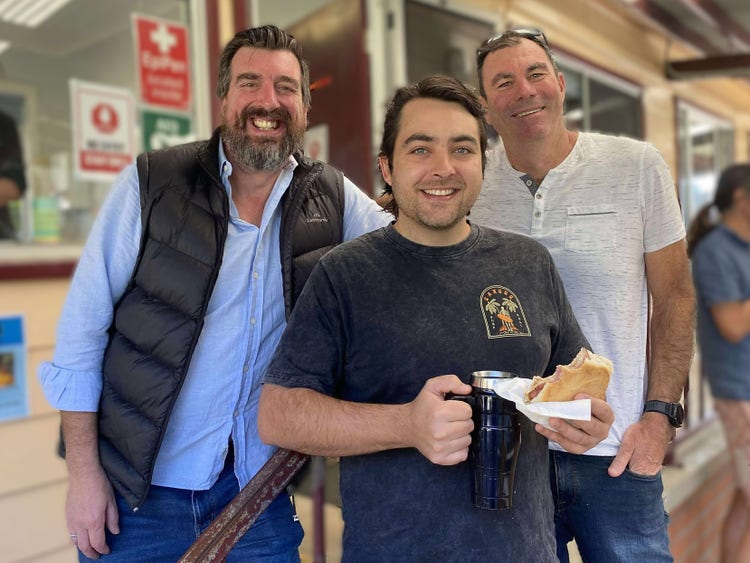 A photo of fathers from the school enjoying a community event.